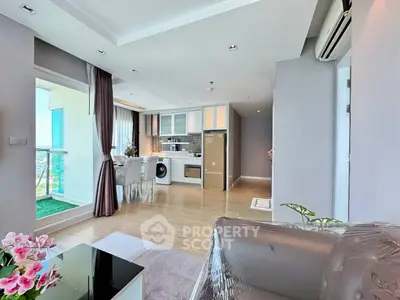 Modern open-plan living room with kitchen and balcony view