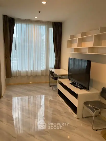 Modern living room with large window and sleek furniture