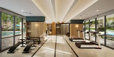 Luxurious gym with modern equipment and pool view in upscale residential complex.