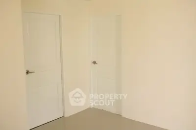 Minimalist interior with two white doors and beige walls