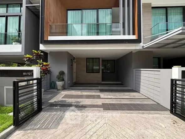 Modern townhouse exterior with sleek design and spacious driveway