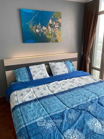 Cozy bedroom with scenic wall art and large window view