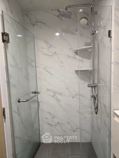 Modern bathroom with sleek glass shower and marble tiles