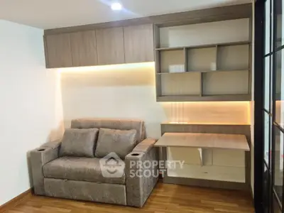 Modern living room with stylish sofa and built-in wooden shelves