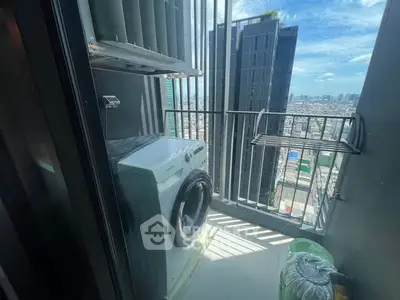 High-rise apartment balcony with washing machine and city view