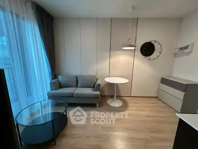 Modern living room with stylish furniture and large window