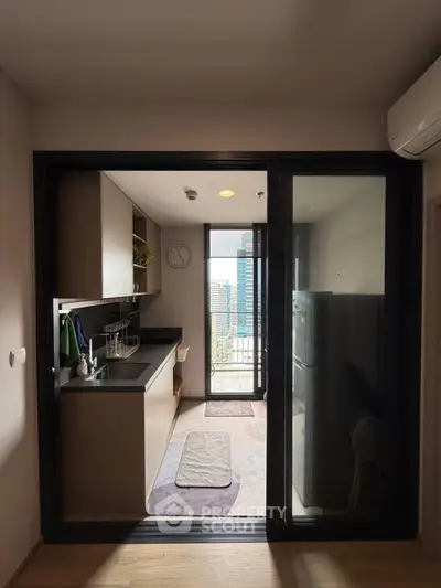 Modern kitchen with sleek design and city view, featuring open layout and stylish appliances.