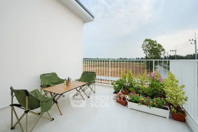 Spacious balcony with scenic view and cozy seating area, perfect for relaxation.