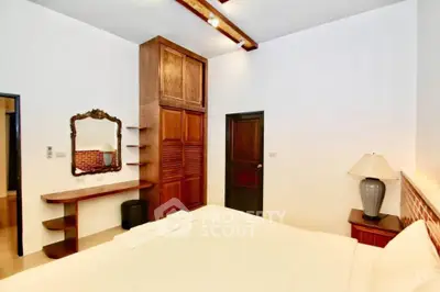 Spacious bedroom with elegant wooden furniture and stylish decor