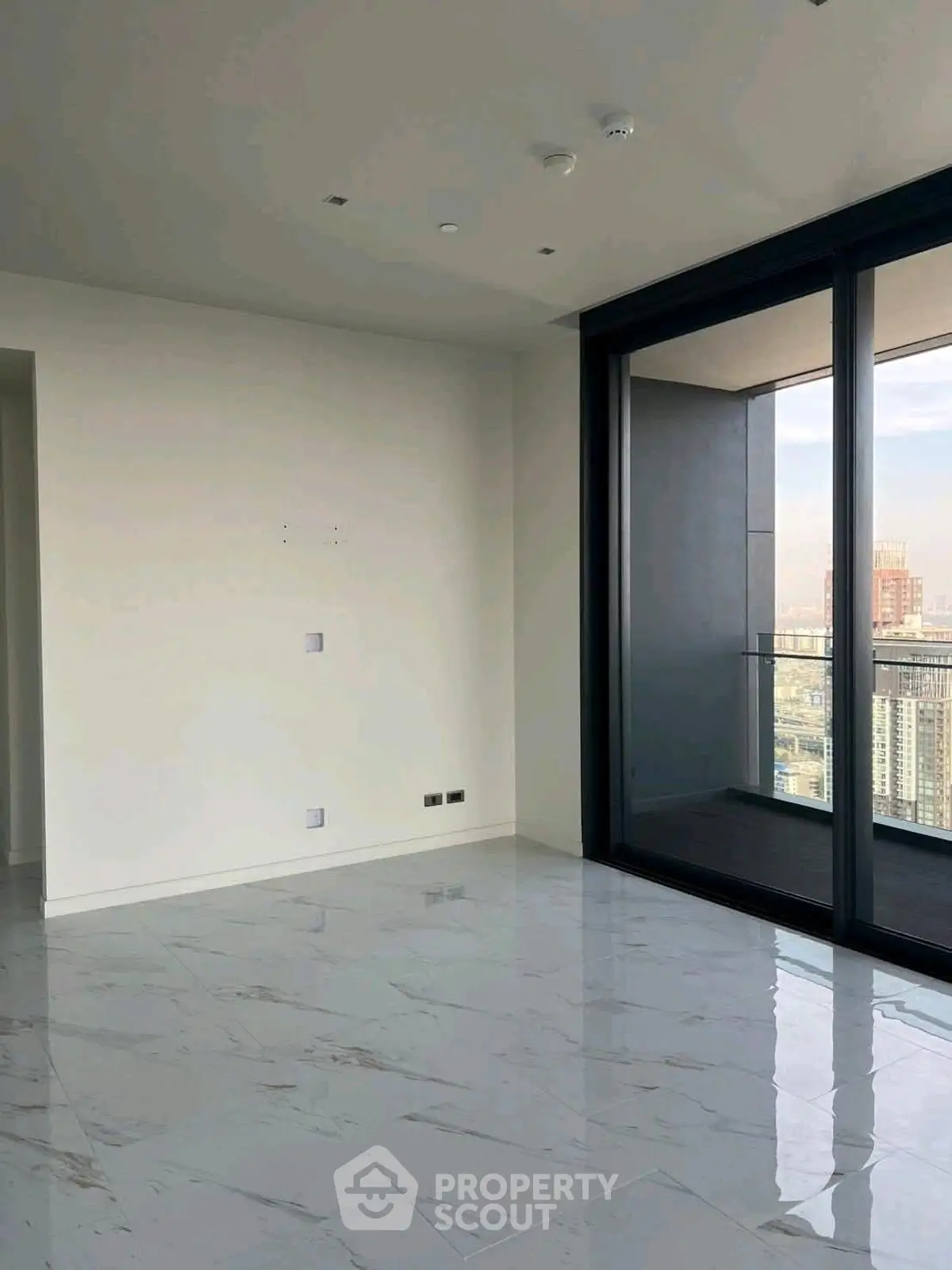 Spacious modern apartment with marble floors and stunning city view from balcony.