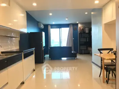 Modern open-layout living room with sleek kitchen and large windows