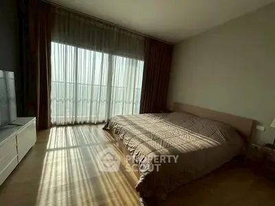 Spacious bedroom with large window and natural light