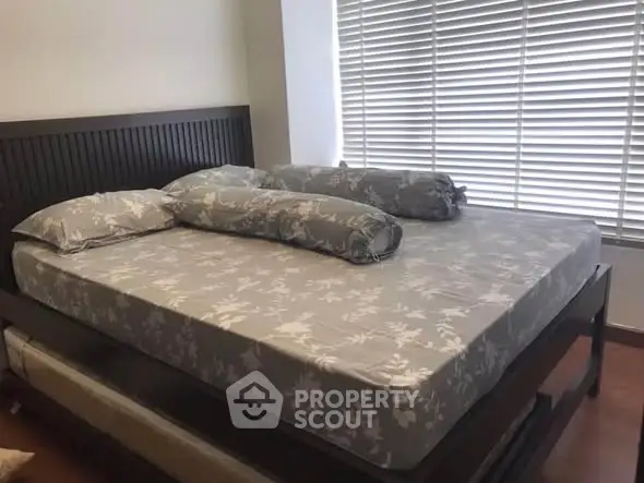 Spacious bedroom with elegant bed and large window blinds