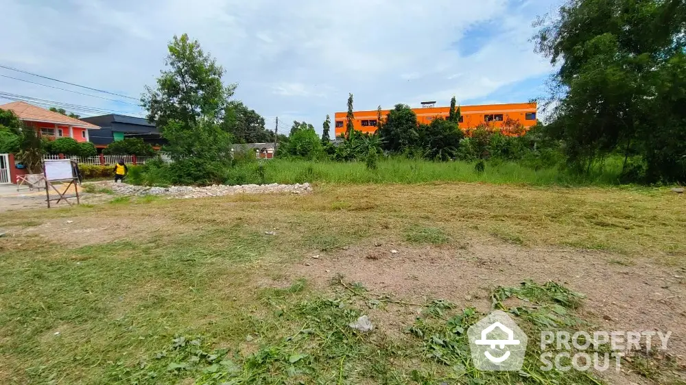 Spacious vacant land plot with lush greenery, ideal for development in a serene neighborhood.