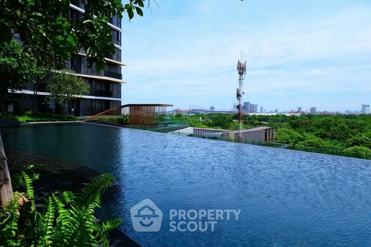 Luxurious infinity pool with stunning cityscape and lush greenery views