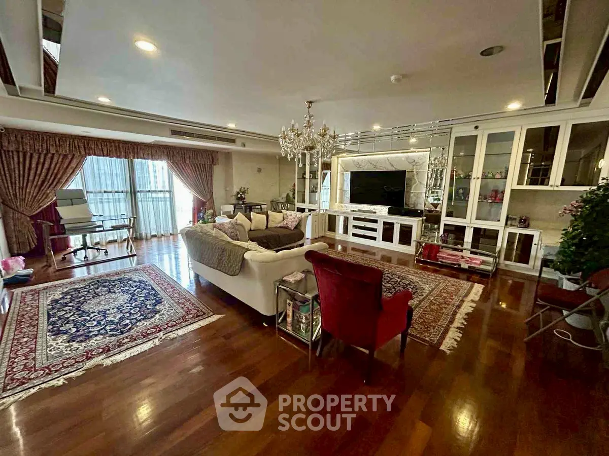 Luxurious living room with elegant decor, hardwood floors, and a chandelier, perfect for sophisticated living.