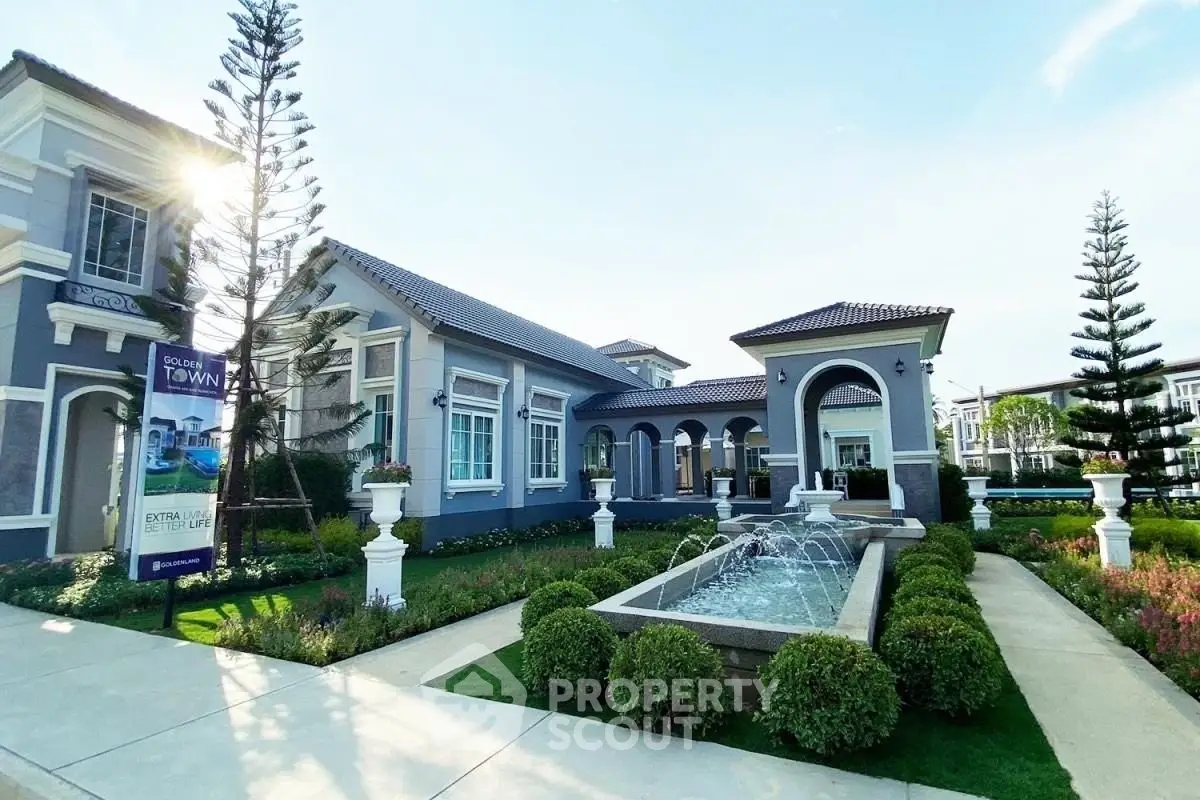 Luxurious modern home with elegant landscaping and fountain in upscale neighborhood.