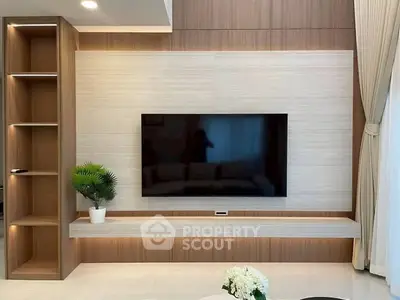 Modern living room with sleek TV setup and elegant shelving