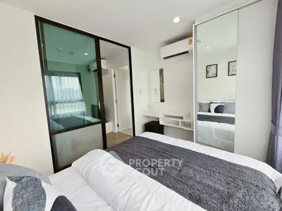 Modern bedroom with mirrored closet and air conditioning in stylish apartment