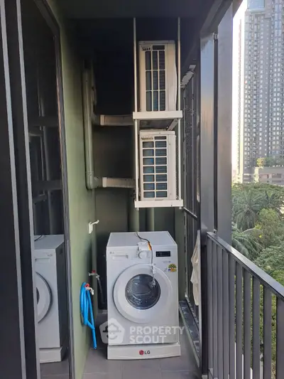 Compact balcony with washing machine and city view, ideal for urban living.