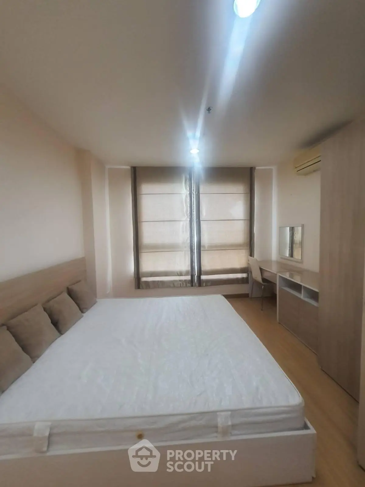 Modern bedroom with large window and minimalist furniture