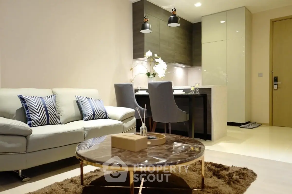 Modern living room with elegant decor and open kitchen layout