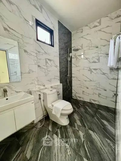 Luxurious modern bathroom with marble tiles and sleek fixtures