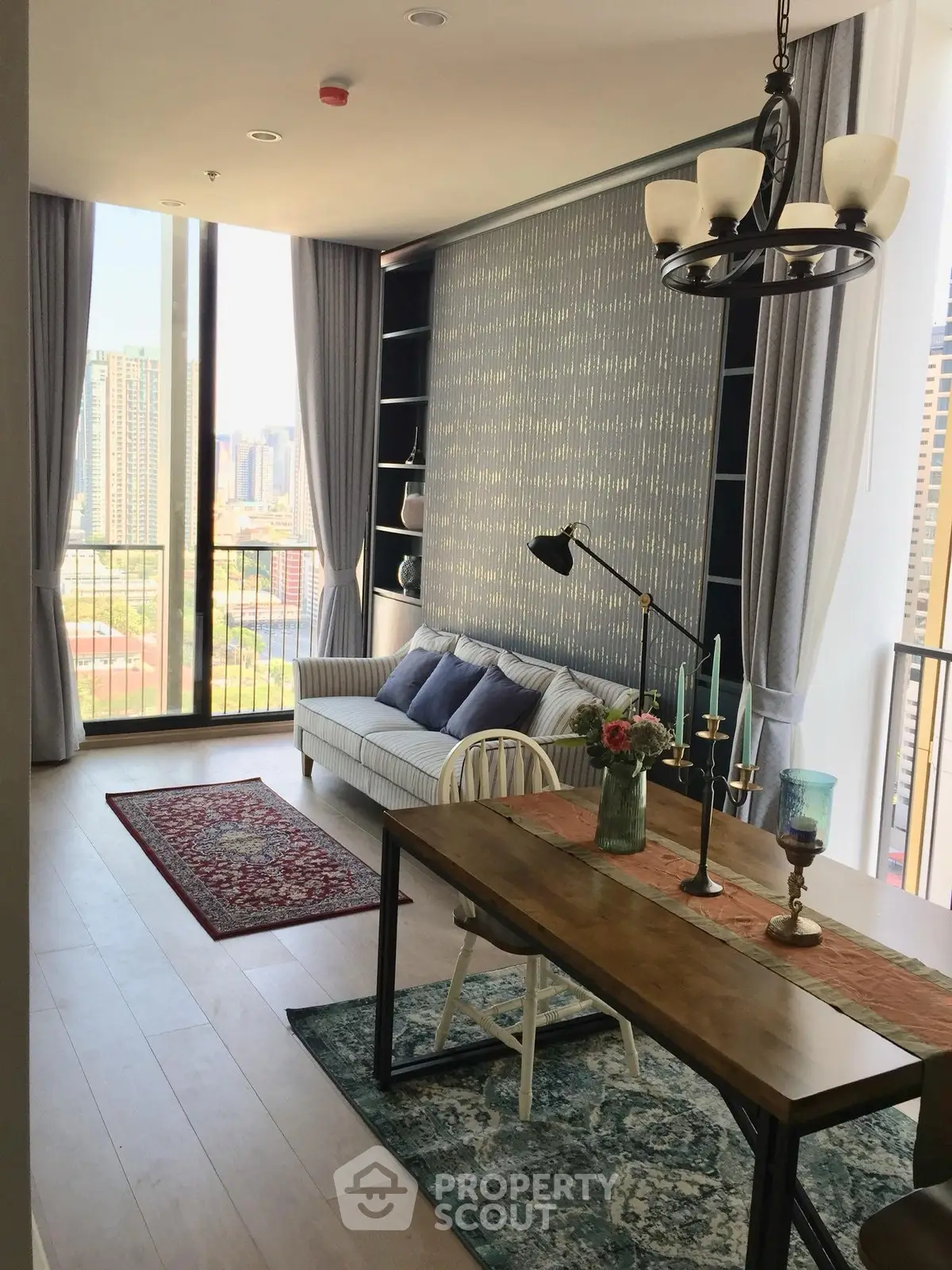Stylish living room with city view, modern decor, and elegant lighting.
