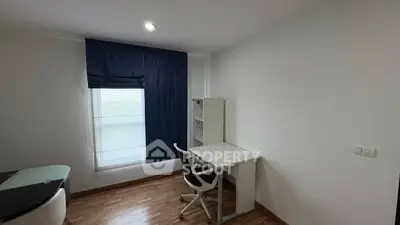 Modern study room with sleek desk and chair, featuring natural light and minimalist design.