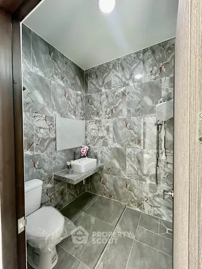 Modern bathroom with marble tiles and sleek fixtures