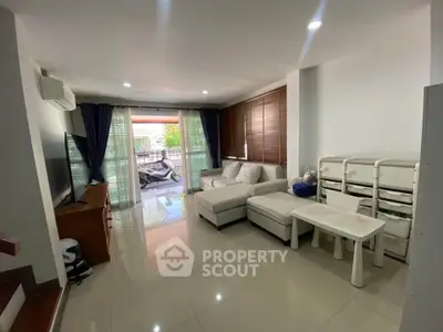 Spacious living room with modern furniture and large windows for natural light.