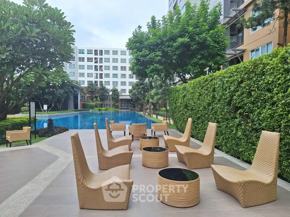 Luxurious outdoor pool area with stylish seating in modern apartment complex