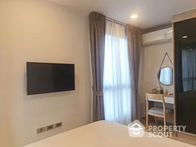 Modern bedroom with wall-mounted TV and stylish vanity area