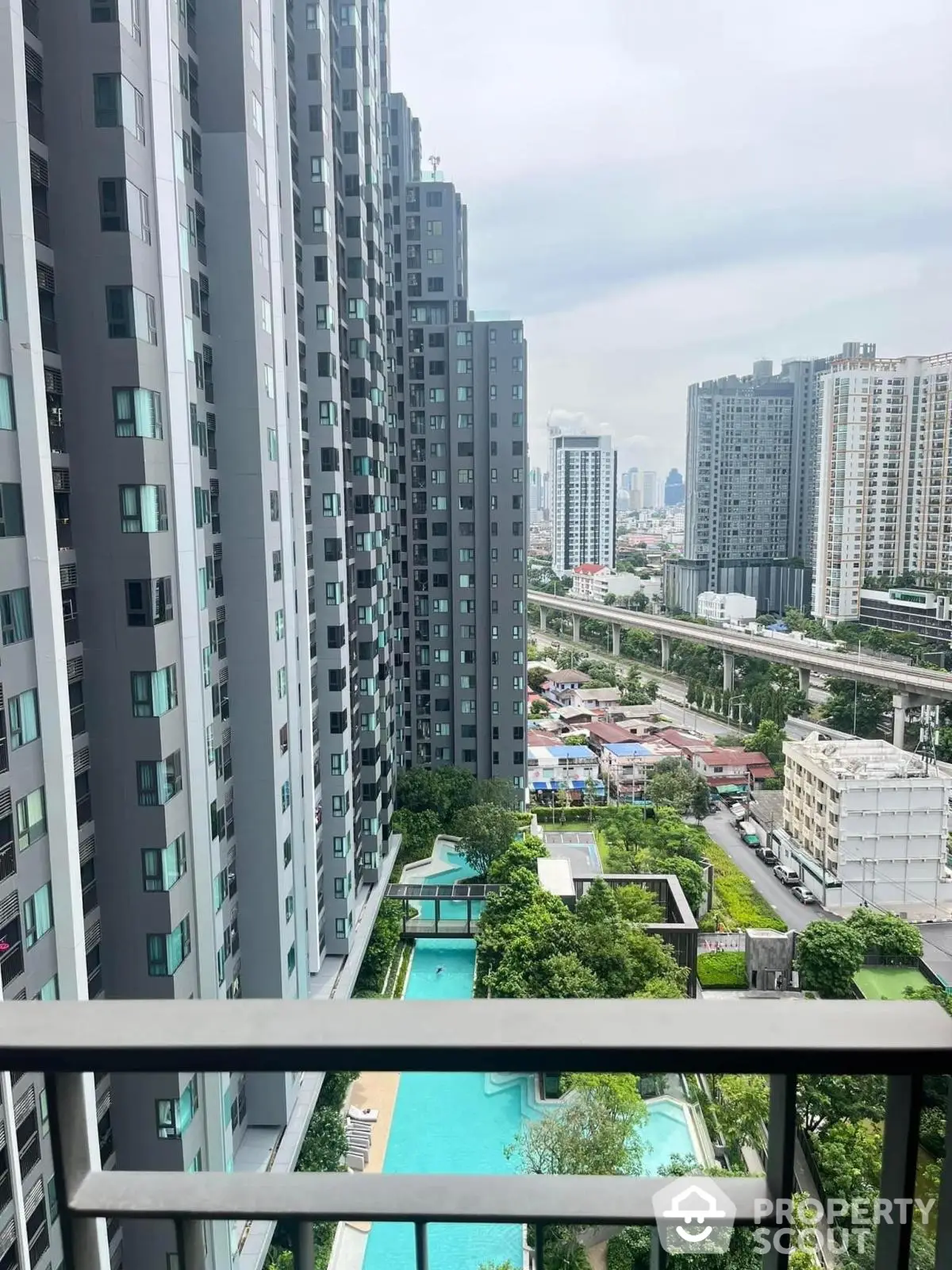 Stunning high-rise apartment view with pool and cityscape, perfect urban living experience.