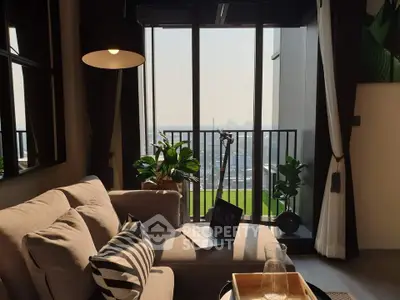 Modern living room with cozy sofa and balcony offering stunning city view