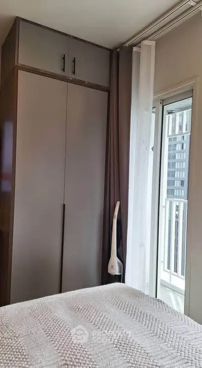 Modern bedroom with balcony access and sleek wardrobe design
