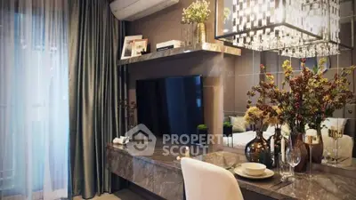 Luxurious living room with elegant decor and modern TV setup, featuring stylish lighting and sophisticated furnishings.