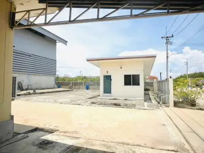 Spacious industrial property with open yard and utility building, ideal for business operations.