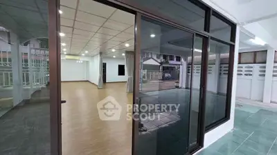 Spacious modern interior with large glass doors and open layout, perfect for versatile living or office space.