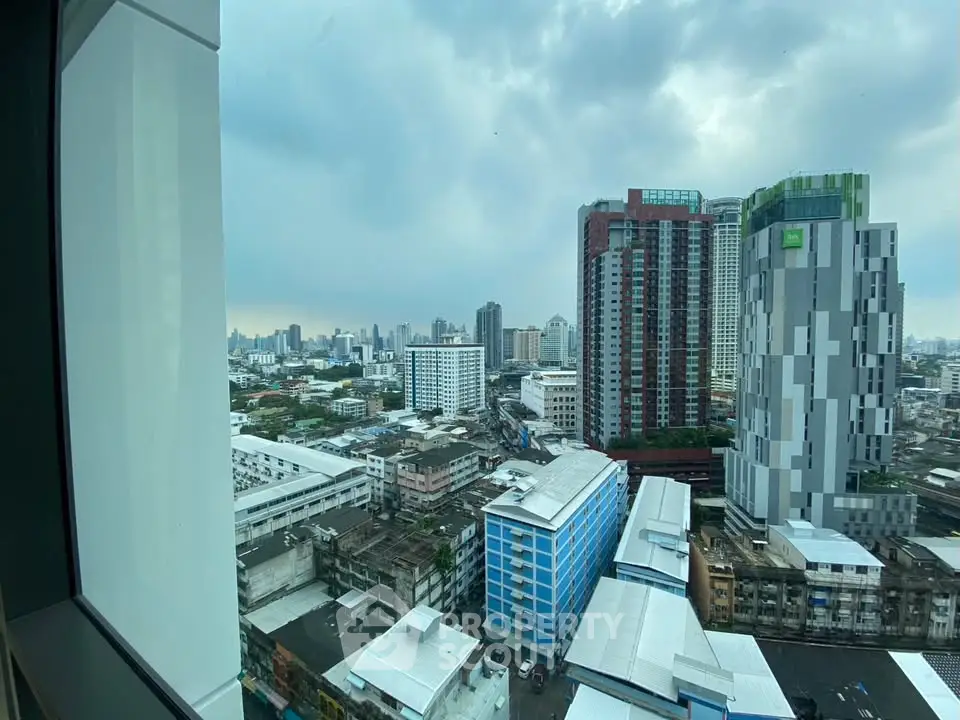 Stunning cityscape view from high-rise building window showcasing urban skyline.