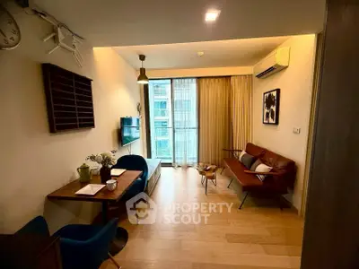 Stylish living room with modern decor and natural light in urban apartment.