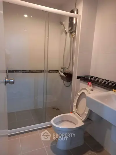 Modern bathroom with glass shower enclosure and sleek fixtures