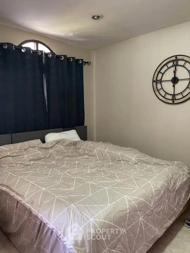 Cozy bedroom with stylish decor and large bed, perfect for relaxation.