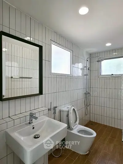 Modern bathroom with sleek fixtures and white tiled walls