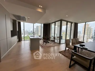Spacious modern living room with open kitchen and stunning city views in luxury apartment.