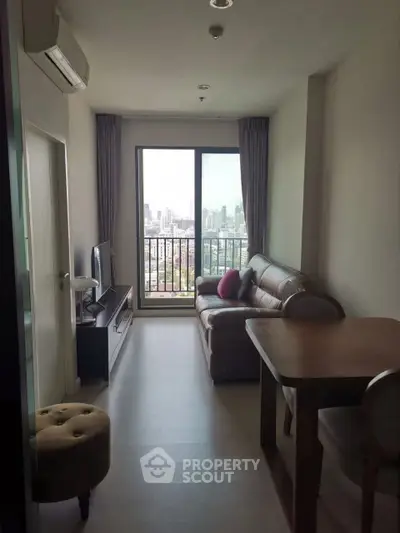 Cozy living room with city view, featuring leather sofa and modern decor.