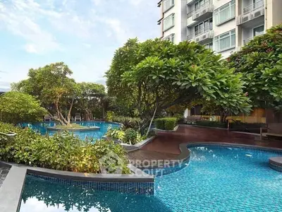 Luxurious residential building with lush garden and stunning pool area