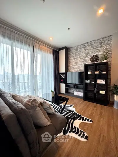 Modern living room with stylish decor and large windows offering natural light.