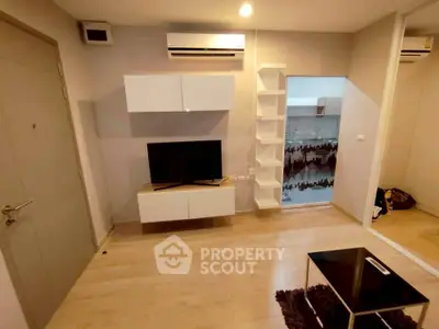 Modern living room with sleek furniture and air conditioning in a stylish apartment.