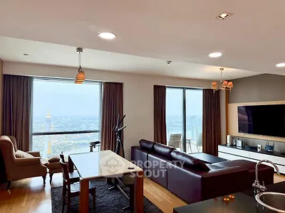 Luxurious living room with stunning city view and modern furnishings.